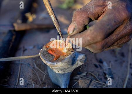 Bushman von der Ju/'Hoansi-San produziert giftige Pfeile aus einem Larven der Buschmann Pfeil - Gift Käfer (Diamphidia Stockfoto