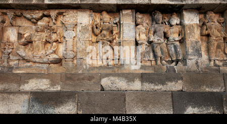 Reliefs auf einen Korridor an der Wand. Borobudur buddhistischen Tempel, Magelang Regency, Java, Indonesien. Stockfoto