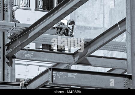 Bauarbeiter arbeiten am Hochhaus Stockfoto