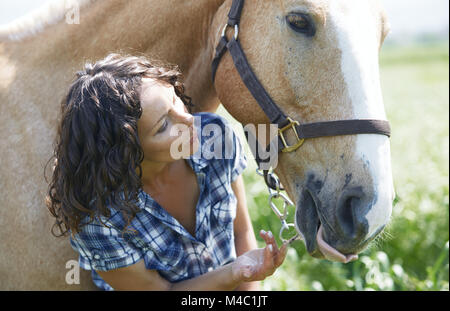 Frau und Pferd zusammen im Fahrerlager Stockfoto