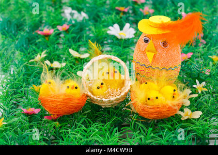 Ostern Einstellung mit Hühnern und Ei auf Gras Hintergrund. Stockfoto