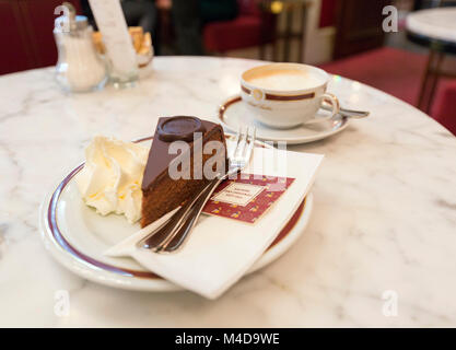 Expresso trinken und Sacher Torte im Café Sacher. In Wien, Österreich. Dieses ist, wo die ursprüngliche Torte erstellt wurde. Stockfoto