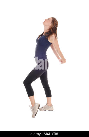 Schlanke Frau im Profil, Stretching. Stockfoto