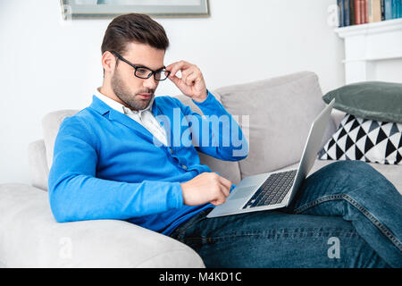 Junger Mann geduldiges Warten psychologie Sitzung surfen Laptop Stockfoto