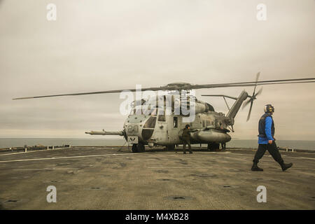 Ein U.S. Marine Corps CH-53E Super Stallion Helikopter mit Marine Medium Tiltrotor Squadron 162 (verstärkt), 26 Marine Expeditionary Unit (MEU) beruht auf der fllight Deck an Bord der Station Landung Schiff USS Oak Hill (LSD 51) Bei Flugbetrieb vor der Küste von North Carolina in den Atlantik, 14.02.2018. Die 26. MEU ist die Teilnahme an einem Einsatz auf See see- und friedenserhaltende Maßnahmen durchzuführen, sowie die Pflege der Beziehungen zu ausländischen Armeen durch gemeinsame Übungen. (U.S. Marine Corps Foto: Staff Sgt. Dengrier M. Baez) Stockfoto