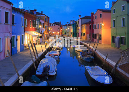 Ein Kanal mit bunten Häusern in Burano (Venedig), Italien gesäumt in der Dämmerung Stockfoto