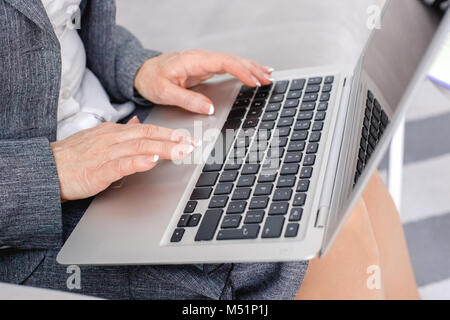 Frau Psychologin Portrait sitzen an Casual home office surfen Laptop close-up Stockfoto