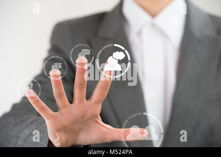 Business Frau zeigt ihre Finger auf virtuellen Web interface Symbole Stockfoto