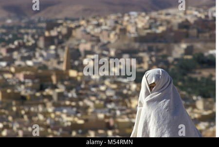 Algerien. Ghardaia. M'zab Tal. Sahara. Oasis. Verschleierte Frau vor der City. UNESCO Weltkulturerbe. Stockfoto