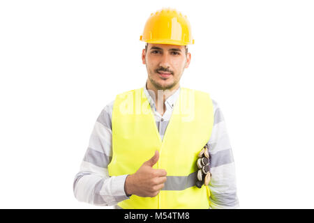 Jung und gutaussehend hardhat Arbeiter zeigen thumbsup tragen Bau builder Ausrüstung auf weißem Hintergrund Stockfoto