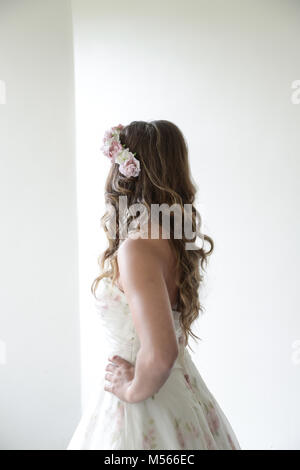 Porträt einer schönen Modell Tragen eines weißen Designer Wedding Dress - einfacher weißer Hintergrund & Fenster Beleuchtung Stockfoto