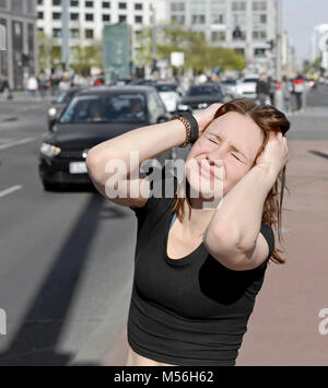 Junge Frau deckt Ihre Ohren Stockfoto