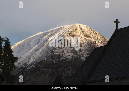 Der Lake District, Cumbria, im Winter mit Schnee auf den Gipfeln. Kirche St. Bartholomä, Loweswater mit Grasmoor darüber hinaus. Stockfoto