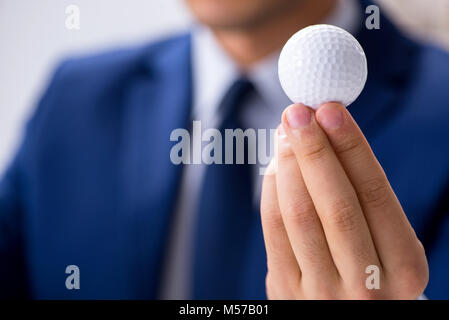 Junge Unternehmer mit Golf ball Arbeiten im Büro Stockfoto