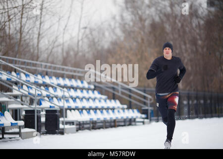 Bild des Athleten in schwarzer Kleidung bei Stadion Stockfoto