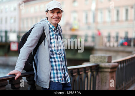 Reifen Tourist mit Rucksack auf dem Uferdamm des Griboyedov Kanal in St. Petersburg, Russland Stockfoto