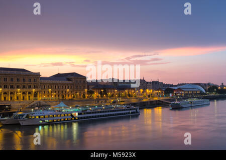 Sára Salkaházi riverfront mit Corvinus Universität Gebäude und Schiffe an Pier, Sunrise, Budapest Stockfoto