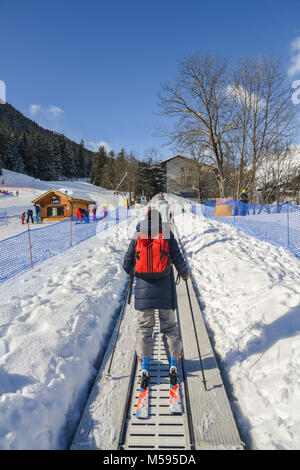 La Thuile, Italien - 18.Februar 2018: die ansteigenden Förderband zu einem Anfänger für Kinder und Eltern im Skigebiet mit Bergen im Hintergrund ausführen Stockfoto