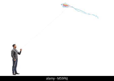 Volle Länge Profil Schoß eines jungen Kerl flying a Kite auf weißem Hintergrund Stockfoto