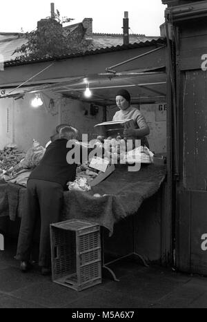 Großbritannien, Wales, Cardiff, Stadtzentrum, Hayes, alte Cardiff offenen Markt Obst und Gemüse Stand im frühen Morgen vorbereiten zu öffnen, vor dem Abriss 1970 s Stockfoto