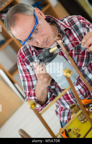 Klempner arbeiten mit einem Brenner Stockfoto