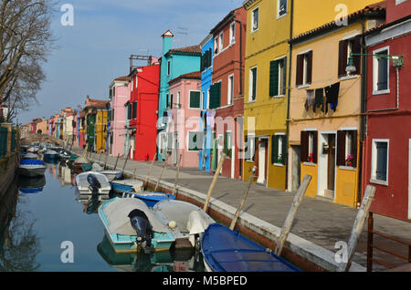 Kanal mit Booten gesäumt von bunten Häusern auf der Insel Burano in der Lagune von Venedig, Italien Stockfoto