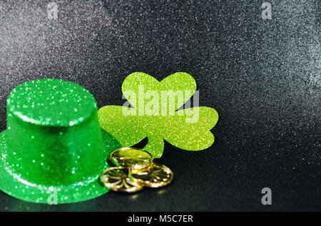 St Patrick's Grüner Hut mit grünen Four Leaf Clover und Goldmünzen. Stockfoto