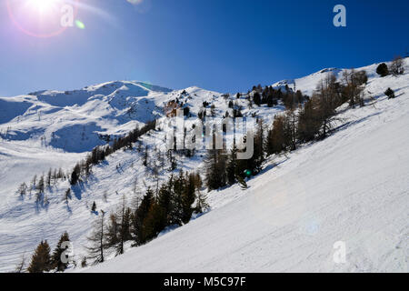 Steilen Gradienten Piste in den italienischen Alpen gegen einen schönen blauen Himmel und Sonne flares - Pila, Vale d'Aosta, Italien Stockfoto