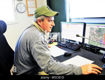 Bereichsschaltung Techniker Mark Rücksprache mit der Direktion der Pläne, Ausbildung, Mobilisierung und Sicherheit arbeitet am Feuer Schreibtisch am 31.01.16, 2018, am Fort McCoy, Wis. Der Schreibtisch betreibt die Kommunikation mit Einheiten, die mit Hilfe der Strecke Komplex sowie Bereich Wartung und anderen Personals über 46.000 Hektar Ausbildung Bereiche auf Fort McCoy. (U.S. Armee Stockfoto