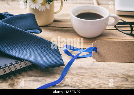 Vatertag Konzept. Blaue Krawatte mit einem Leeren leeren tag, Büro Schreibtisch Hintergrund, Platz für Text Stockfoto