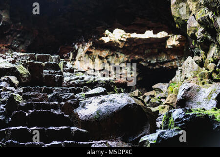 Eine Wanderung durch eine Lava Höhle in Island Tunnel sind sehr schmal und teilweise blockiert Stockfoto