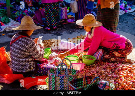 Eine lokale Landwirte Frau verkauft, Zwiebeln und Kartoffeln in den Markt von Stadt Stockfoto