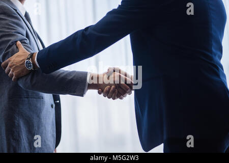 Anspruchsvolle Geschäftsleute Händeschütteln mit einander nach einem Abkommen. Geschäftsleute, die Hände zu schütteln und ein Abkommen. Stockfoto