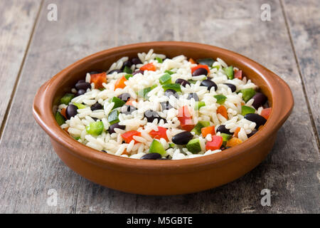 Traditionellen kubanischen Reis, schwarzen Bohnen und Paprika auf hölzernen Tisch Hintergrund. Moros y Cristianos. Stockfoto