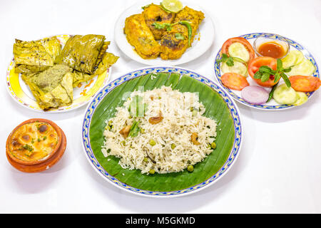 Beliebte leckere Bengali indische Küche Mahlzeit mit Gemüse gebratener Reis, Würziger Fisch Curry, Salate und Süßspeise. Stockfoto