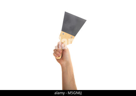 Hand mit einem metallspachtel auf weißem Hintergrund Stockfoto
