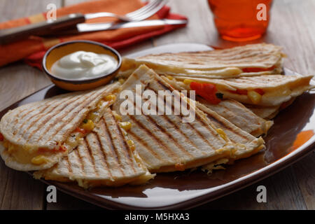 Vegetarische quesadilla mit Paprika, Mais, Käse und saurer Sahne. Selektiver Fokus auf der Vorderseite Keil Stockfoto