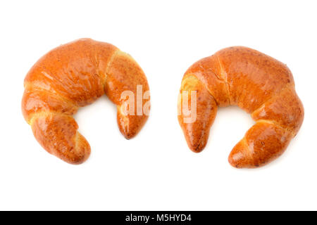 Frisch gebackene Croissants auf weißem Hintergrund. Ansicht von oben. Stockfoto