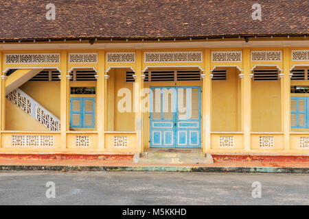 Blaue Türen auf gelbem Hintergrund außerhalb der Cao Dai Tempel Heiliger Stuhl, Tay Ninh Provinz, Vietnam. Stockfoto