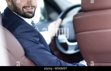 Unternehmer sitzen am Steuer eines Autos, und wenn man die Kamera Stockfoto