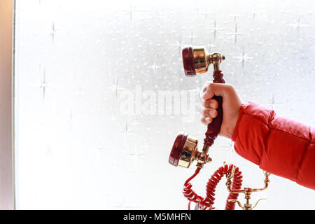 Woman's Hand mit Retro rot Telefon. Stockfoto
