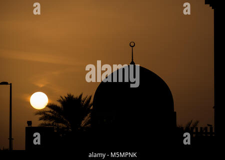 Die Moschee Kuppel Silhouette gegen Orange Himmel bei Sonnenuntergang Stockfoto