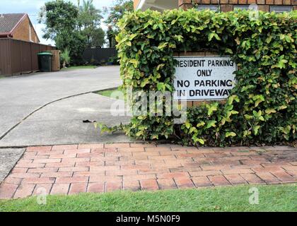 Schild "Resident Parken nur. Kein Parkplatz in der Auffahrt." Zeichen an der Wand außerhalb der Auffahrt. Stockfoto