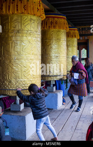 Thimpu, Bhutan. Anbeter Drehen Gebetsmühlen an der National Memorial Chorten. Stockfoto