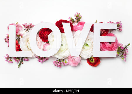 Kreative Gestaltung mit bunten Blumen, Blättern und das Wort LIEBE. Flach. Stockfoto