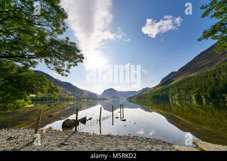 Blick über den Lake Buttermere vom Kiesstrand Ufer im englischen Lake District an einem Sommertag, UK. Stockfoto