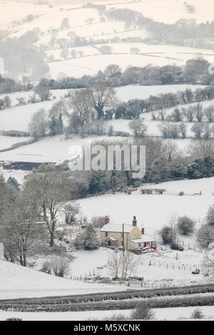 Flintshire, Wales, Großbritannien, 27. Februar 2018, UK Wetter: Das Tier aus dem Osten kommt mit einer Rache bei Temperaturen unter -3C und starke Schneefälle in Flintshire. Eine verschneite Landschaft umgibt, einem ländlichen Bauernhof in der Nähe des Dorfes Rhes-y-Cae mit der Clwydian Hügel reichen Hügel in der Ferne, als das Tier aus dem Osten bringt halt über ländliche Flintshire Stockfoto