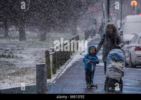 London, Großbritannien. 27 Feb, 2018. Pendler und Familien stehen vor einem miserablen Reise zurück vom Clapham South U-Bahn wie der Schnee bei Minusgraden im Clapham fällt. Credit: Guy Bell/Alamy leben Nachrichten Stockfoto