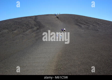 Sicht von Menschen zu Fuß bis cinder Hügel am Krater des Mondes National Monument Stockfoto