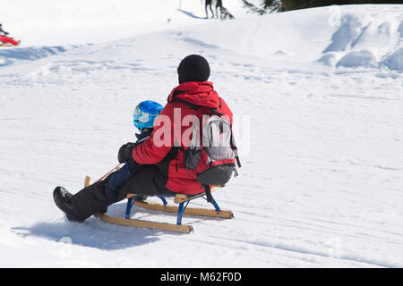 Vater und Sohn Rodeln in Flims Schweiz Stockfoto